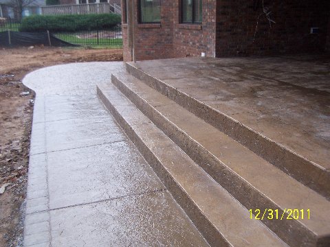 decorative concrete steps and porch sidewalk